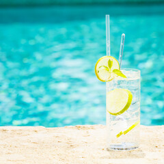 Water with ice at the edge of a resort pool. Concept of luxury vacation