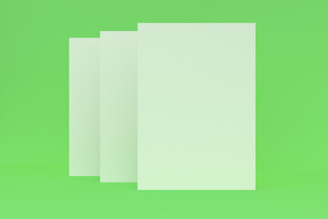 Three blank white closed brochure mock-up on green background