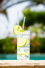 Water with ice at the edge of a resort pool. Concept of luxury vacation