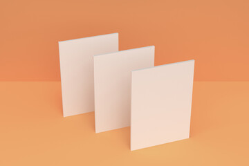 Three blank white closed brochure mock-up on orange background