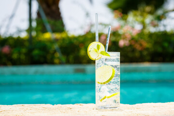 Water with ice at the edge of a resort pool. Concept of luxury vacation