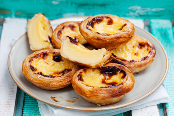 Egg tart. Portuguese dessert. Wooden background.