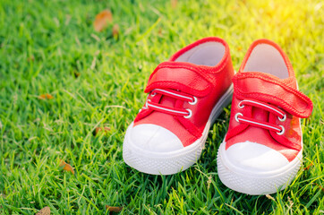 red shoes for children on green grass floor