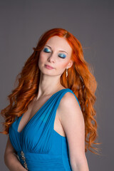 Fototapeta premium Young woman with long red hair