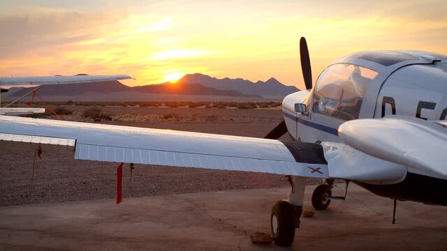 Airplane standing on a airfield in the desert sunset 2