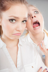 Angry fury girl screaming at her friend or younger sister