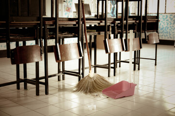 Classroom cleaning with a broom