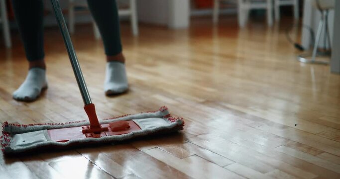 Woman using mop cleaner to do household chores faster
