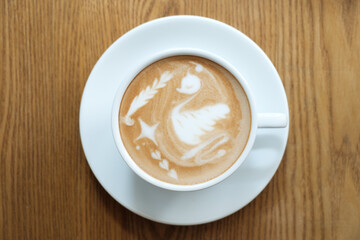 Top view latte art coffee on wood background