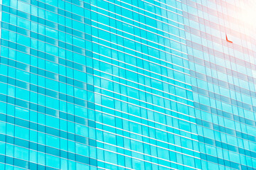 High glass modern building with blue sky and cloud at daylight for abstract background. Soft focus.Facades texture pattern for business background.