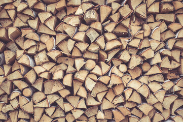 Background of firewood stack. Birch firewood. Wood background