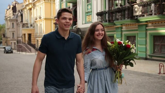 Romantic couple in love strolling down city street