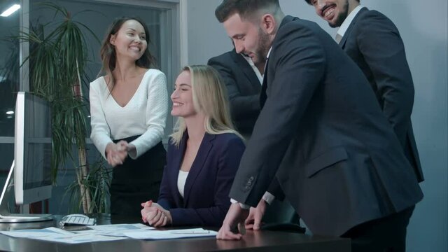 Business people clapping celebrating success at a meeting in the office