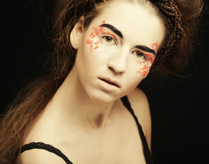 young female face with bright fashion multicolored make-up