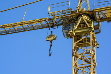 Close up construction crane builds new building
