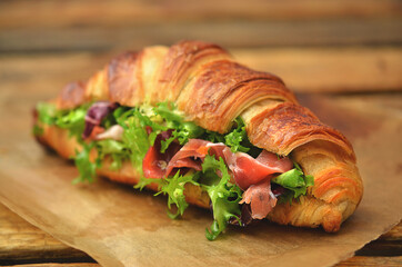 Croissant with lettuce and prosciutto