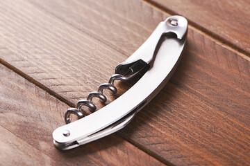 Corkscrew on on wooden table. Horizontal shoot.