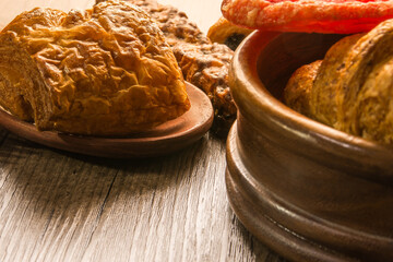 Bakery variety of style and flavors on a wooden table.