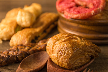 Bakery variety of style and flavors on a wooden table.