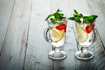 Fresh summer healthy drink with lemon and strawberries with ice.