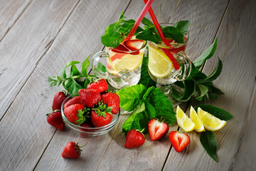 Fresh summer healthy drink with lemon and strawberries with ice.