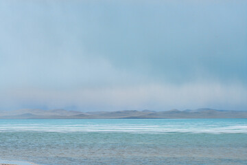 panoramic view of lake at cloudy day with great mountains on background 