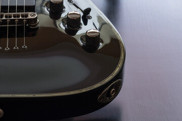 Electric guitar at black background