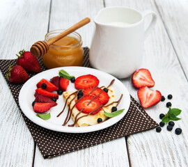crepes with strawberries and chocolate sauce