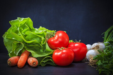 Seasonal mediterranean vegetables, meal ingredients: carrots, tomatoes, lettuce and leeks - spring onions
