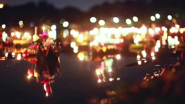 Loy Kratong Festival celebrated in Thailand. Launch boats from beautiful flowers and candles in the pond magic bokeh on the background. 1920x1080