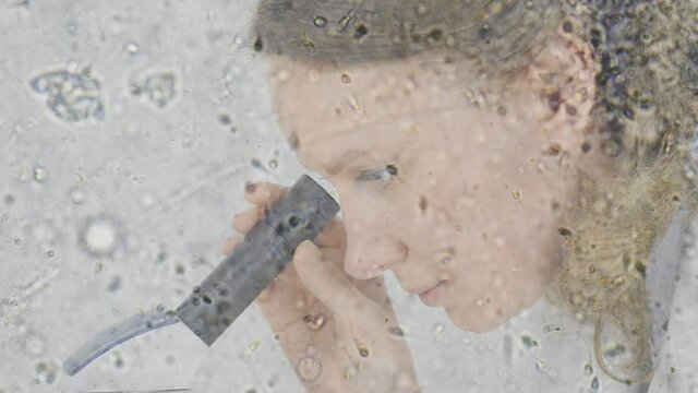The Microscopic World. Doctor looking at the sperm under the microscope.