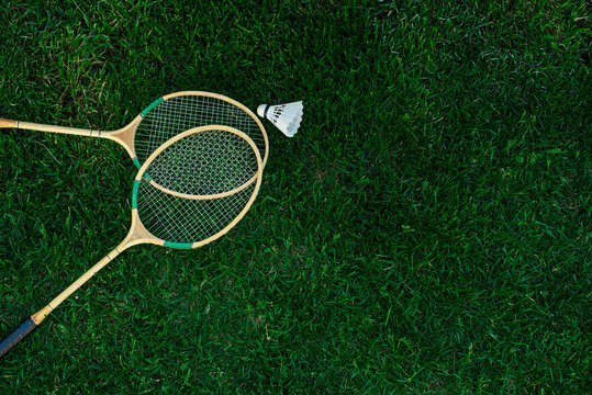 Badminton rackets and shuttlecocks isolated on green, top view, Fresh lawn
