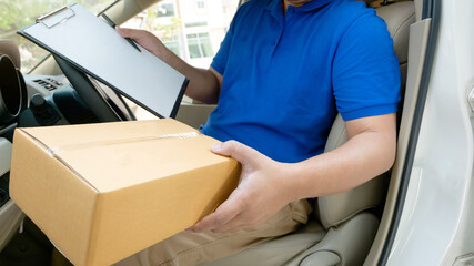 deliverer sitting in a van holding a box