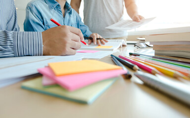 three confident students doing homework together while sitting at the home
