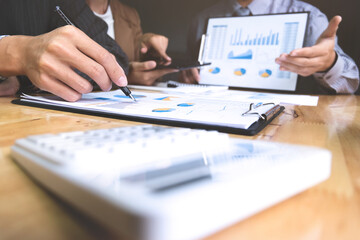 business executives discussing documents and ideas at meeting in a workplace