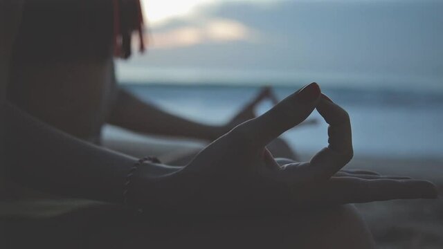 Young woman holding fingers in yoga mudra pose