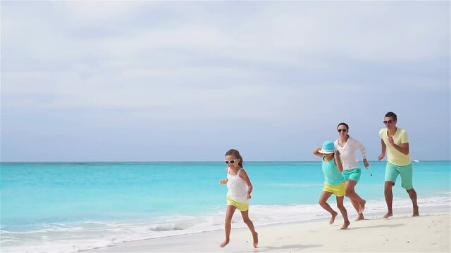 Young family on vacation have a lot of fun on the beach. Slow motion.
