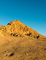 Moon above mountain peak in Death Valley, California, USA