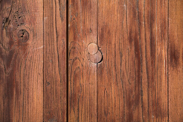 Vintage brown weathered wooden wall with knots