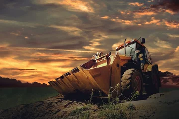 Gordijnen Yellow tractor on sky background © Andrii IURLOV