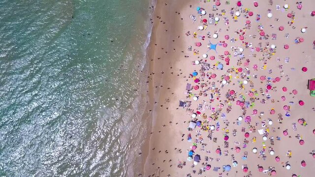 Tropical beach with colorful umbrellas - Top down aerial view