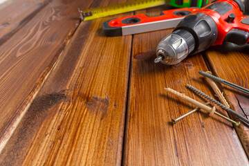 Assorted work tools on wood background