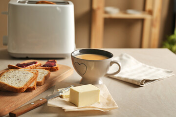Composition with butter coffee and toasts on kitchen table