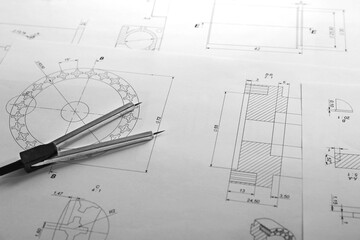Dividers and part blueprints on engineer's workplace