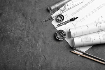 Engineering supplies and part blueprints on workplace
