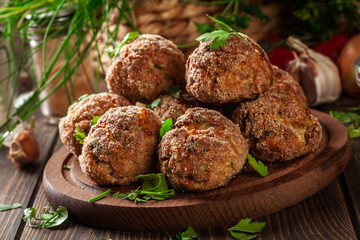 Stack of baked meatballs on a chopping board - obrazy, fototapety, plakaty