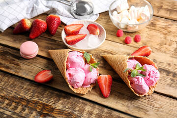 Strawberry ice-cream cones on wooden background
