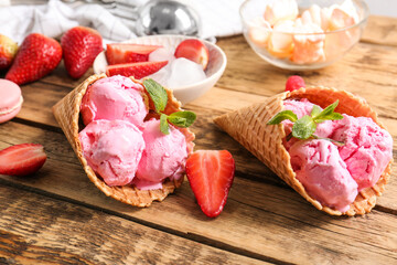 Strawberry ice-cream cones on wooden background