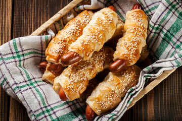 Rolled hot dog sausages baked in puff pastry