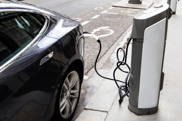 An electric car is refueled in the city